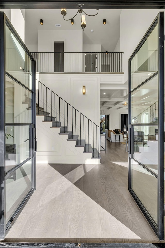 interior space featuring hardwood / wood-style flooring and a towering ceiling