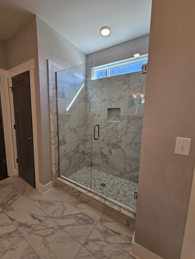 bathroom with a shower with door