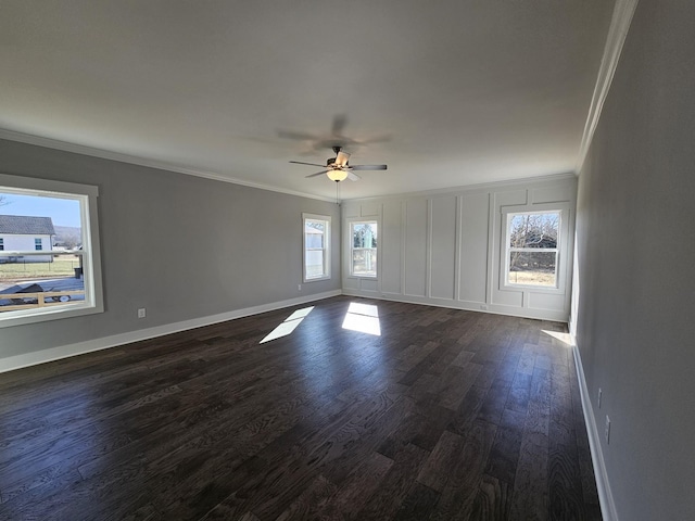 unfurnished room with crown molding, ceiling fan, and dark wood-type flooring