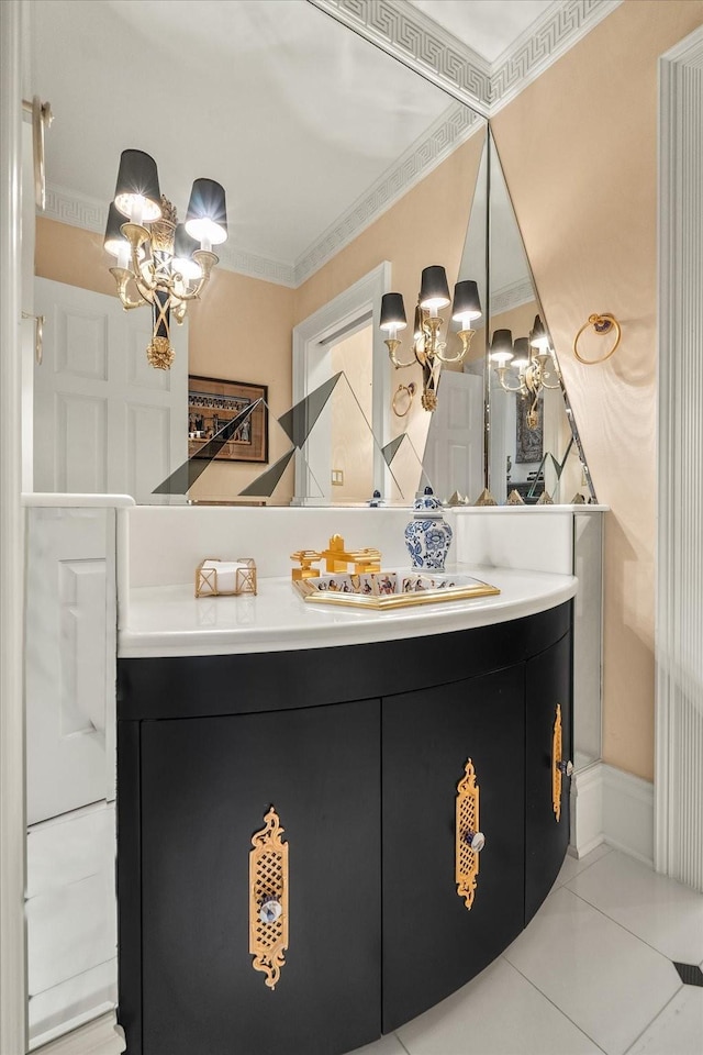 bathroom with a notable chandelier, vanity, crown molding, and tile patterned floors