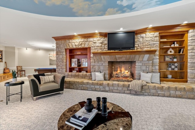 carpeted living area with pool table, recessed lighting, built in shelves, and a stone fireplace