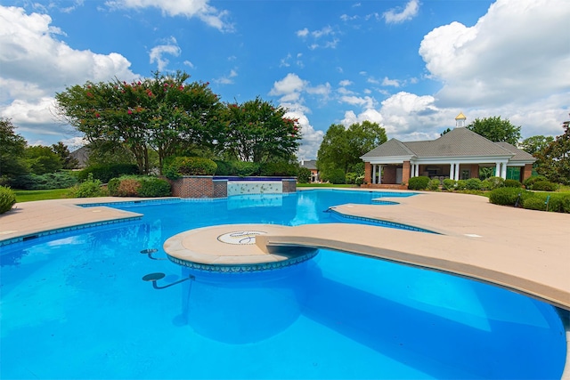 pool with a patio and a jacuzzi