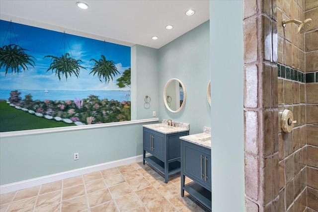 bathroom featuring recessed lighting, baseboards, tiled shower, and vanity