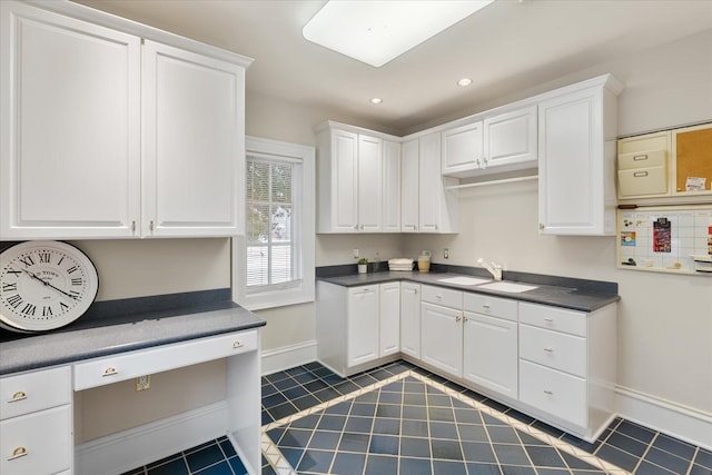 kitchen with dark countertops, dark tile patterned flooring, white cabinets, and recessed lighting