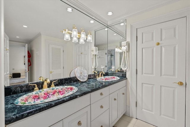 full bath with tile patterned flooring, ornamental molding, and a sink