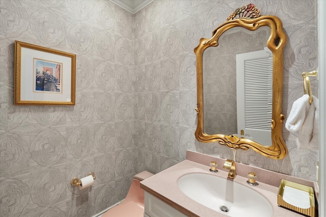 bathroom with wallpapered walls and vanity