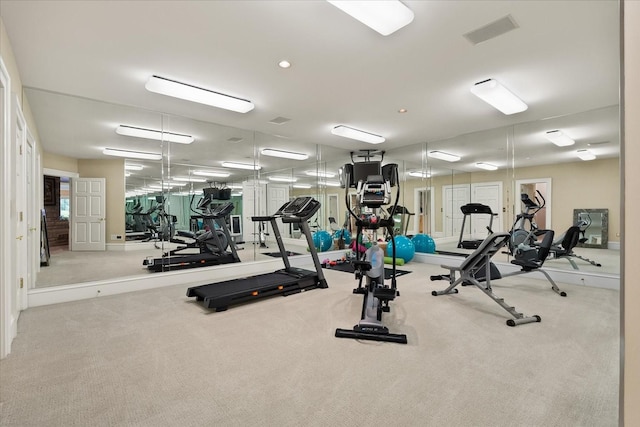 exercise room with carpet floors and visible vents