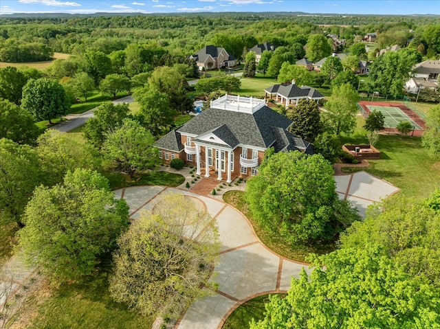 drone / aerial view with a wooded view
