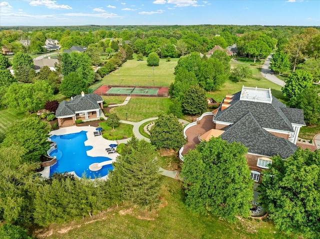 birds eye view of property with a view of trees