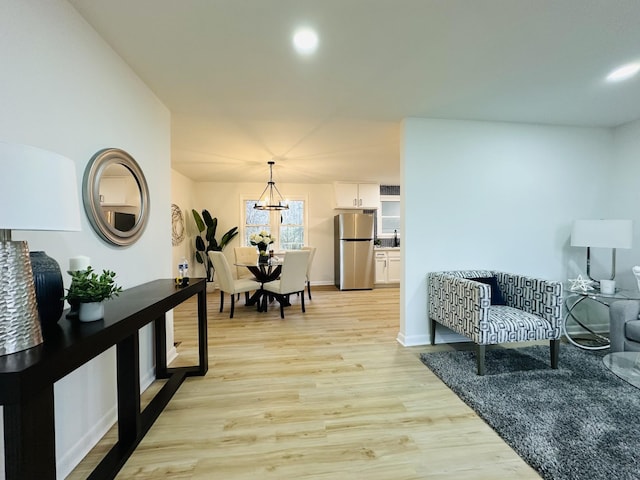 interior space featuring a notable chandelier and light hardwood / wood-style floors