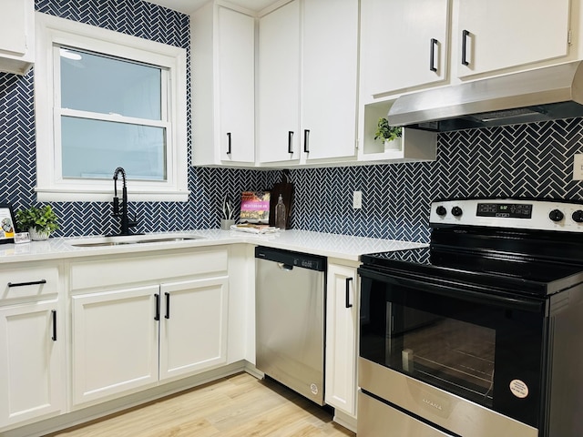 kitchen with white cabinetry, appliances with stainless steel finishes, and sink