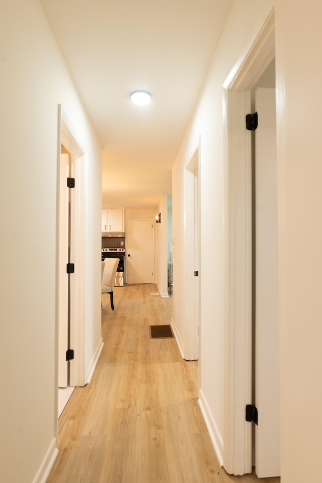 hallway with light wood-type flooring