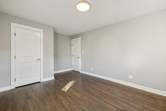 empty room with dark wood-type flooring