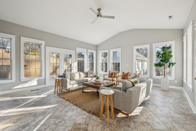 sunroom / solarium with plenty of natural light, lofted ceiling, and ceiling fan