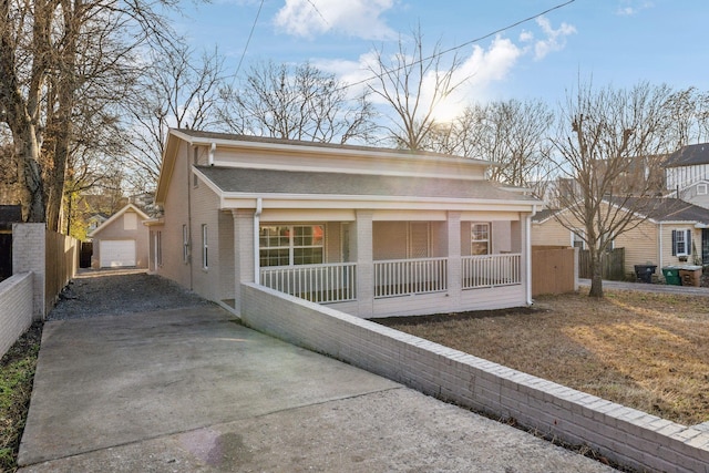 view of front facade featuring a garage, covered porch, and an outdoor structure