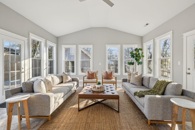 sunroom / solarium with ceiling fan and vaulted ceiling