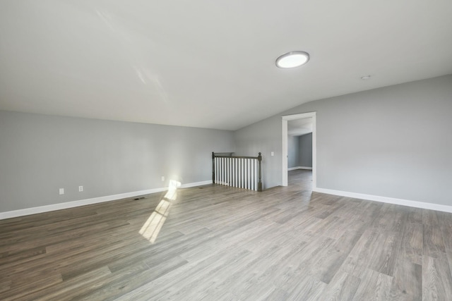 interior space with light hardwood / wood-style floors and vaulted ceiling