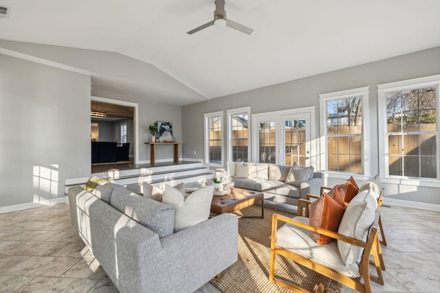 living room with a wealth of natural light, ceiling fan, and vaulted ceiling