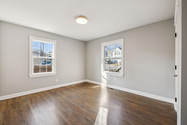 spare room with dark wood-type flooring