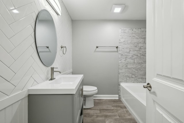 full bathroom with hardwood / wood-style flooring, vanity, toilet, and bathing tub / shower combination