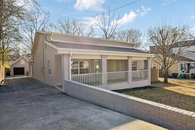 view of front of property with an outdoor structure, a porch, and a garage