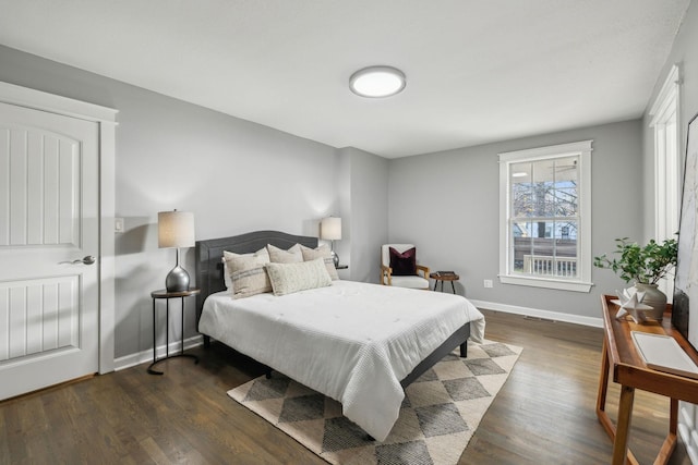 bedroom with dark hardwood / wood-style floors