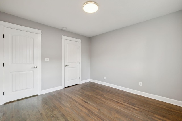 unfurnished bedroom featuring dark wood-type flooring