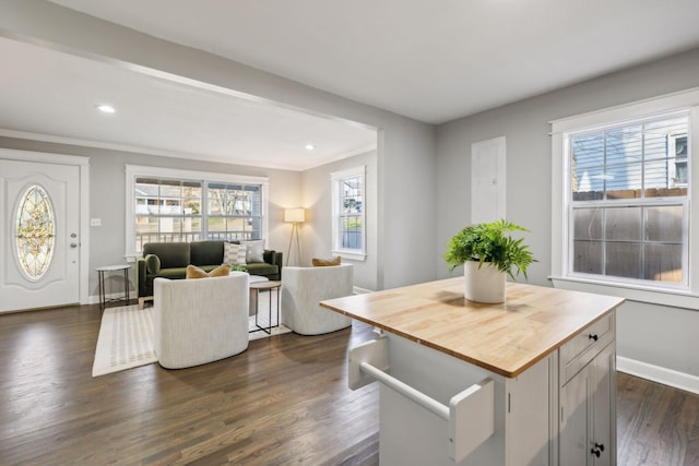 dining room with dark hardwood / wood-style floors and crown molding