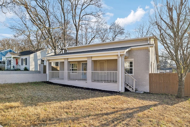 exterior space featuring a porch and a yard