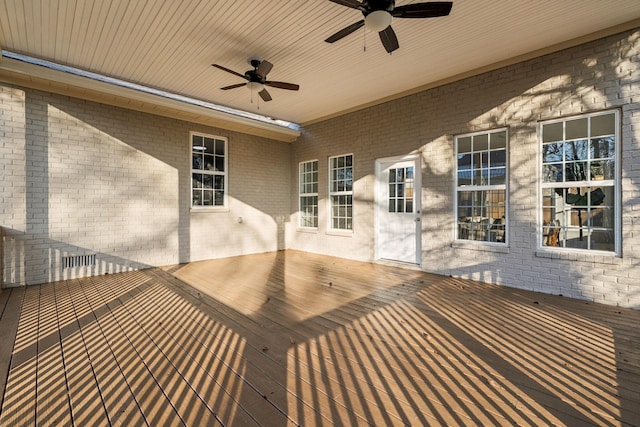 wooden terrace featuring ceiling fan