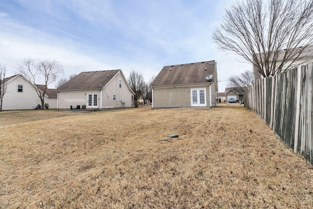 rear view of property with a yard and french doors