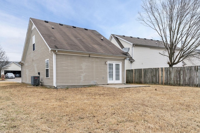 rear view of property with french doors, a yard, cooling unit, and a patio area