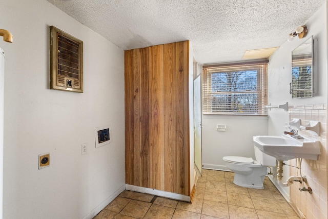 bathroom with tile patterned floors, a textured ceiling, and toilet