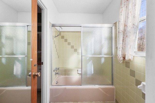 bathroom featuring combined bath / shower with glass door