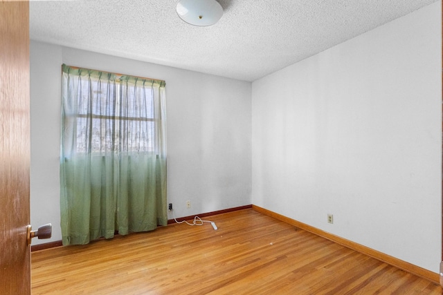 empty room featuring hardwood / wood-style floors and a textured ceiling