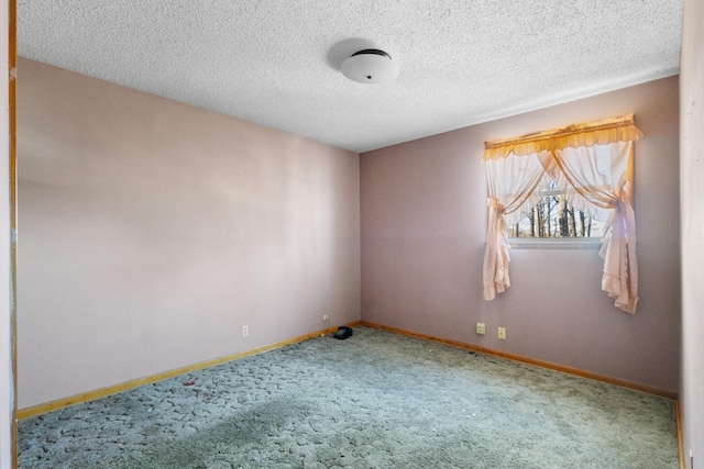 empty room with carpet floors and a textured ceiling