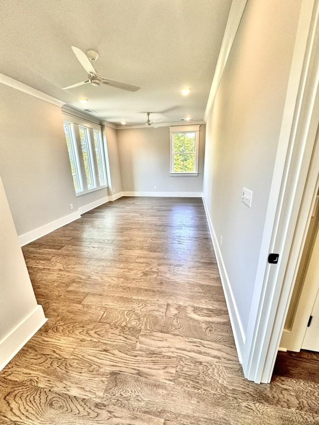 spare room featuring ornamental molding, ceiling fan, a textured ceiling, and wood-type flooring