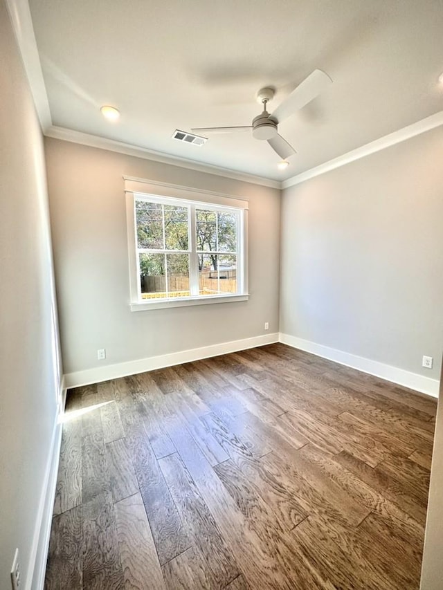 empty room featuring ceiling fan, hardwood / wood-style floors, and crown molding