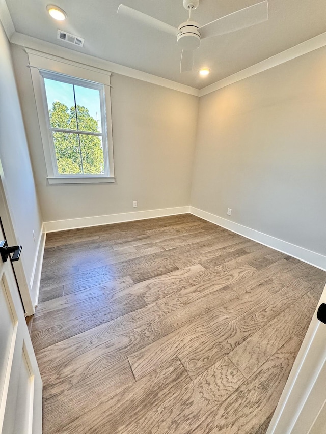 unfurnished room with ceiling fan, hardwood / wood-style floors, and ornamental molding