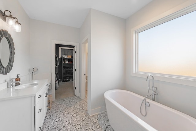 bathroom with vanity and a tub to relax in