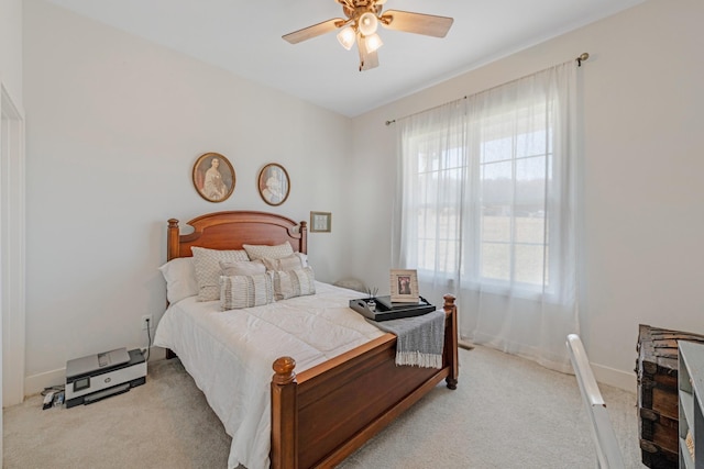 bedroom with ceiling fan and light colored carpet