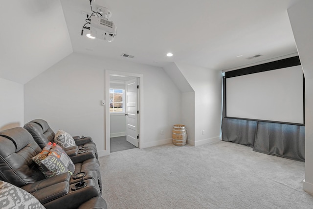 cinema room featuring light colored carpet and vaulted ceiling