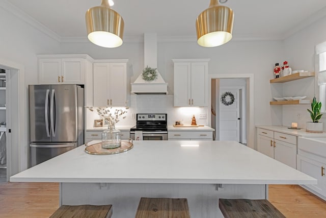 kitchen with white cabinets, premium range hood, stainless steel appliances, and hanging light fixtures