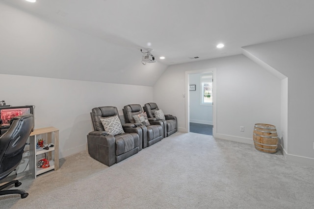 cinema featuring light colored carpet and vaulted ceiling