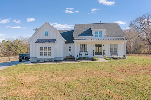 modern inspired farmhouse with a front yard and a porch