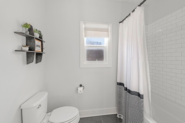 bathroom featuring tile patterned flooring, toilet, and shower / tub combo with curtain