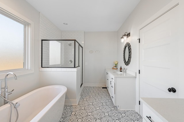 bathroom featuring tile patterned floors, vanity, and shower with separate bathtub