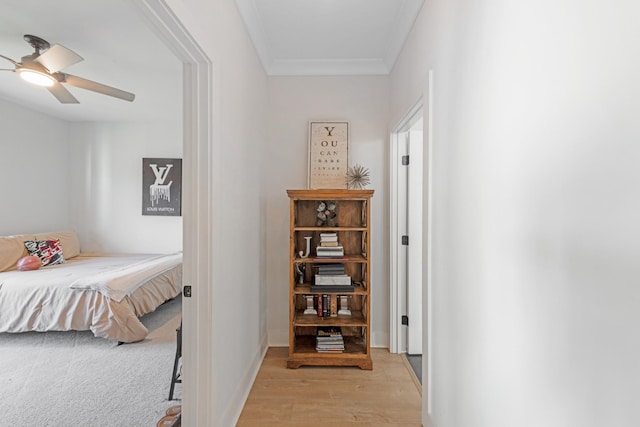 bedroom with ceiling fan, light hardwood / wood-style floors, and ornamental molding