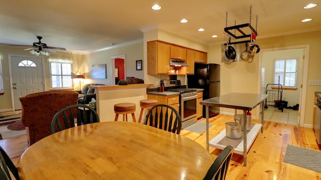 dining room with light hardwood / wood-style flooring, ceiling fan, and ornamental molding