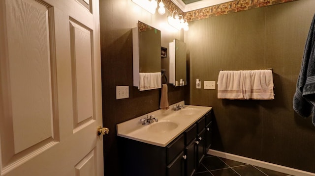 bathroom with crown molding, tile patterned flooring, and vanity